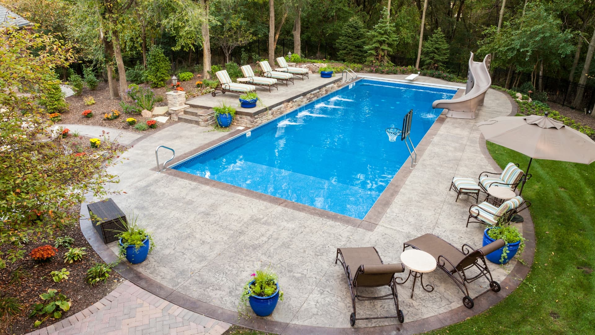 Premium backyard pool with slide and lounge chairs - SGV Pool Maintenance Charlotte NC