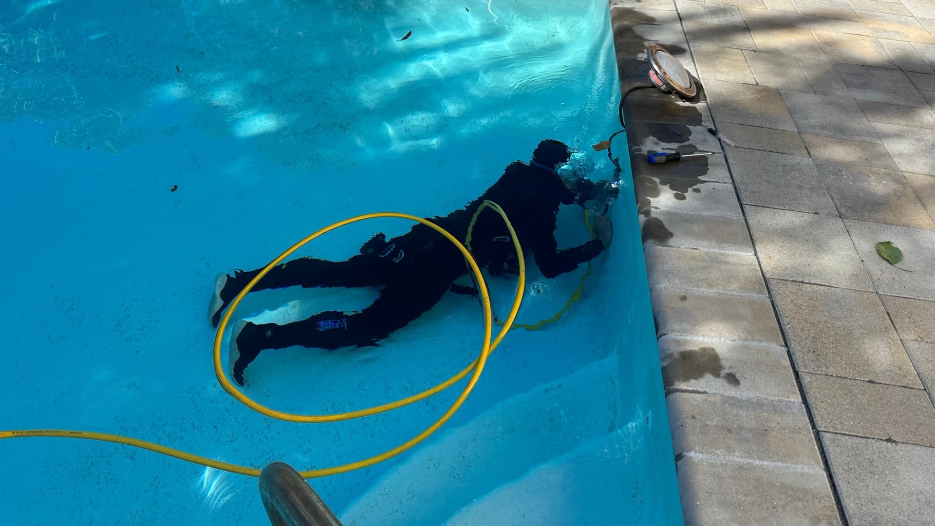 Technician reviewing findings for a pool repair issue